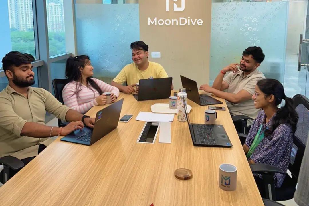 MoonDive designers and engineers around the meeting table in the Noida office
